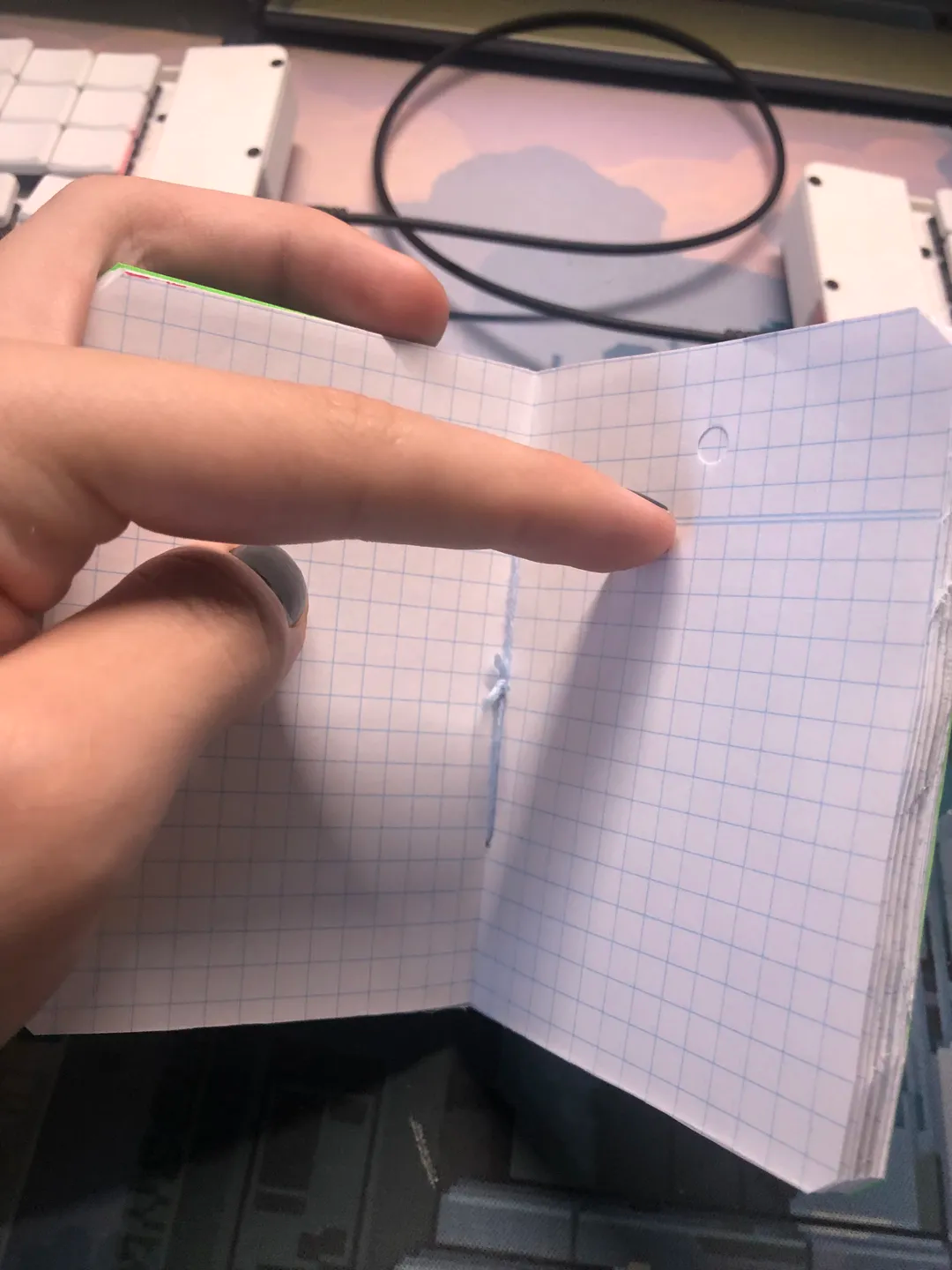 photo of the middle of the notebook, held together by a tied string.